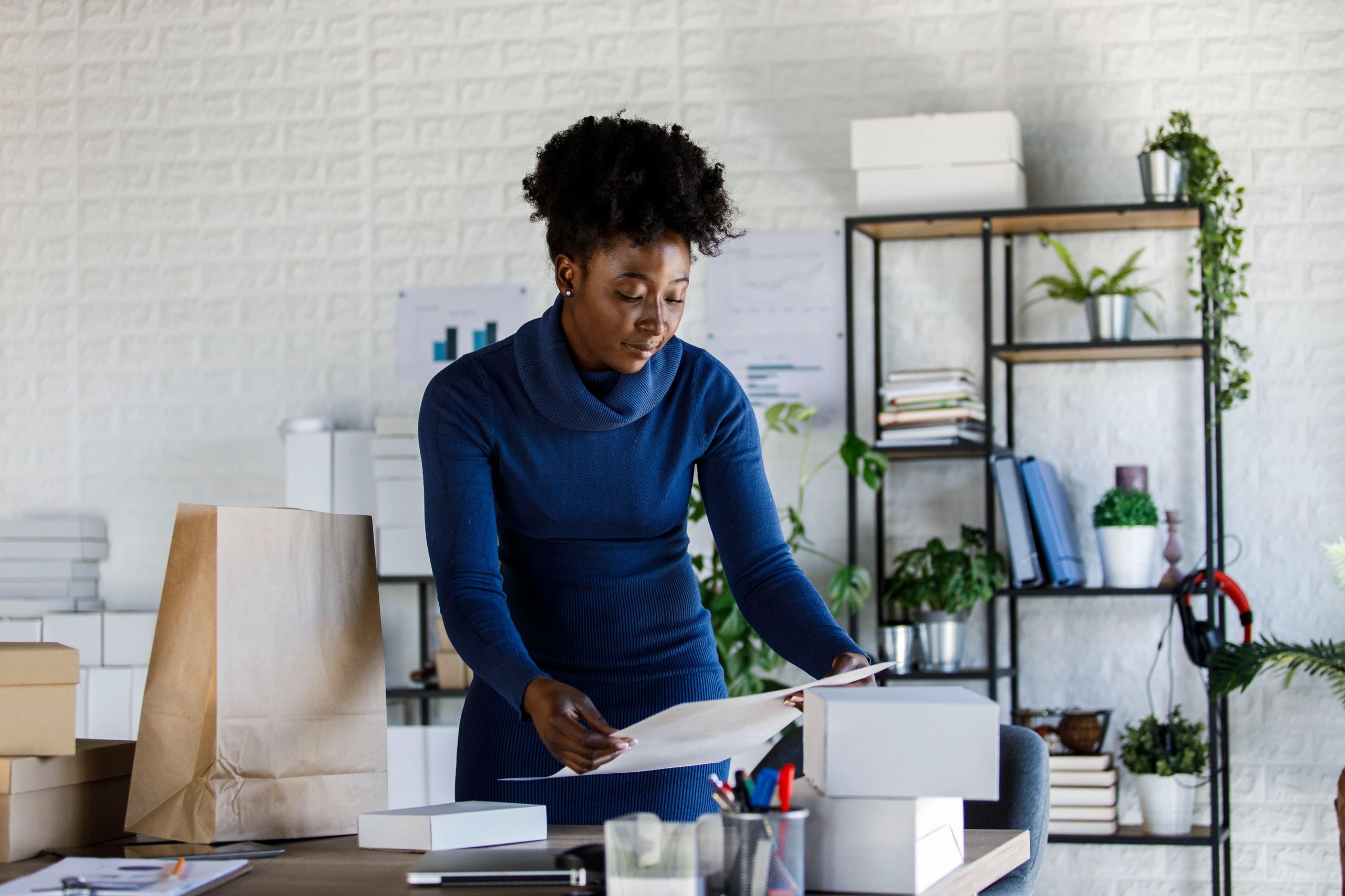 Small business owner preparing packages at a desk